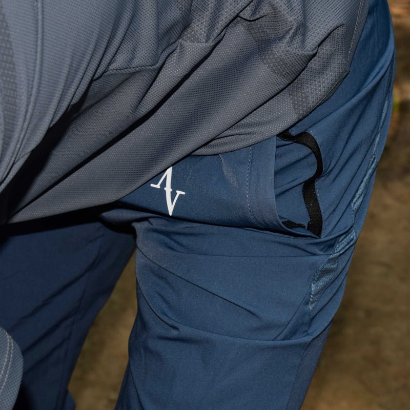 Men's performance jogger pants in navy blue with tapered fit and sweat-wicking fabric, ideal for training or casual wear.